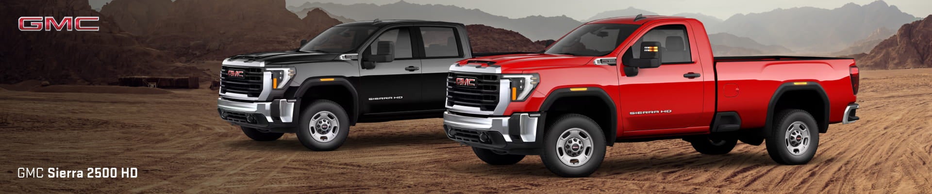 Two 2026 GMC Sierra 2500 HD trucks are parked on a rocky desert landscape.