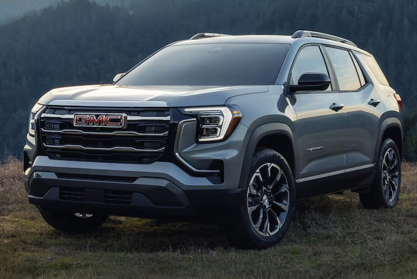 GMC Terrain angled front left exterior view surrounded by mountains